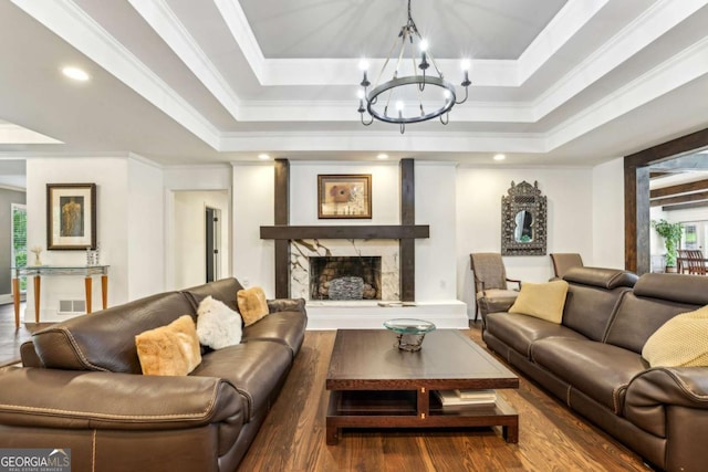 5860 Riverwood Dr, Sandy Springs, GA 30328 - living area with a chandelier, wood finished floors, a high end fireplace, a tray ceiling, and ornamental molding