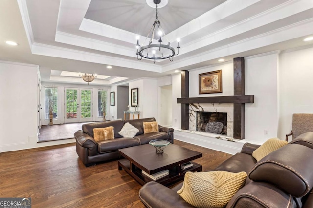 5860 Riverwood Dr, Sandy Springs, GA 30328 - living area featuring a raised ceiling, a chandelier, wood finished floors, a premium fireplace, and recessed lighting