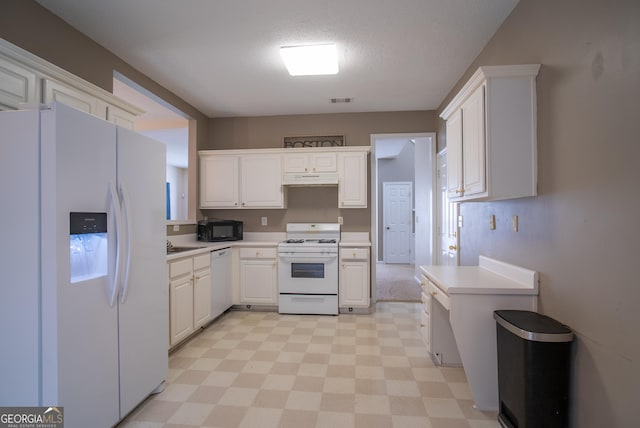 2938 Cottesford Way SE, Smyrna, GA 30080 - kitchen with white appliances, under cabinet range hood, light floors, and light countertops
