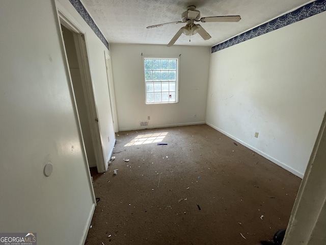 8423 Avalon Dr, Riverdale, GA 30274 - unfurnished bedroom with baseboards, a textured ceiling, and a ceiling fan
