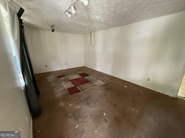 8423 Avalon Dr, Riverdale, GA 30274 - spare room featuring unfinished concrete floors and a textured ceiling