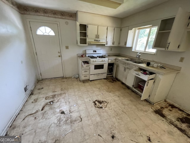 8423 Avalon Dr, Riverdale, GA 30274 - kitchen with white range with gas stovetop, a sink, open shelves, and under cabinet range hood