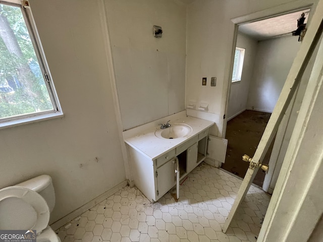 8423 Avalon Dr, Riverdale, GA 30274 - half bathroom featuring plenty of natural light, toilet, and vanity