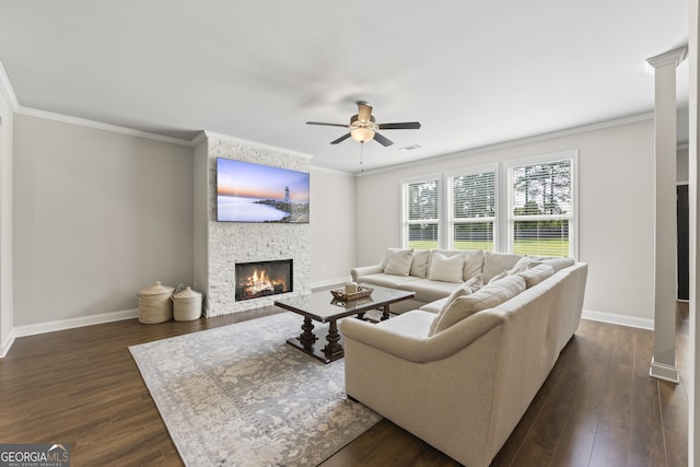 830 Tom Miller Rd, Bethlehem, GA 30620 - living area featuring a stone fireplace, a ceiling fan, baseboards, ornamental molding, and dark wood-style flooring