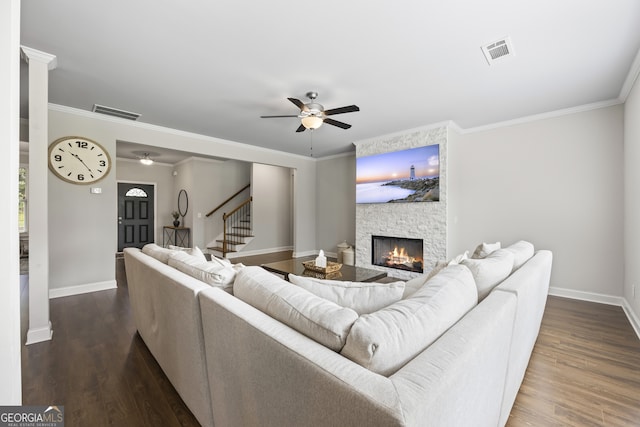 830 Tom Miller Rd, Bethlehem, GA 30620 - living room featuring baseboards, ceiling fan, a stone fireplace, crown molding, and dark wood-style flooring