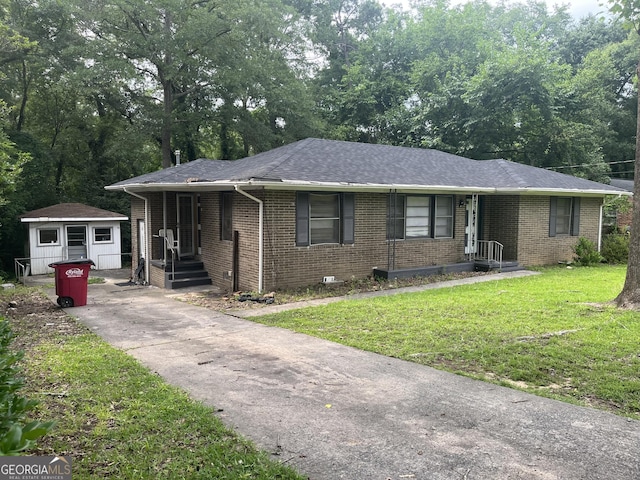 2526 Kensington Rd, Macon, GA 31211 - ranch-style house with brick siding, a front lawn, an outbuilding, and roof with shingles