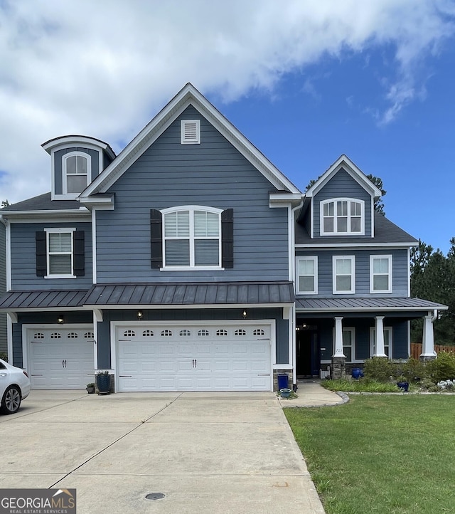 703 Burch Creek Dr, Grovetown, GA 30813 - view of front facade featuring a standing seam roof, concrete driveway, a front lawn, and a garage