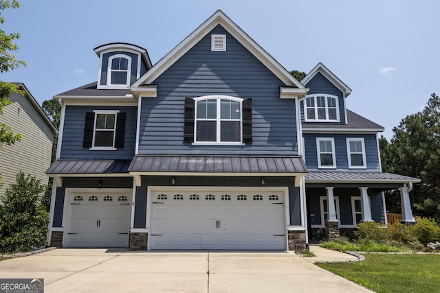 703 Burch Creek Dr, Grovetown, GA 30813 - view of front of house with a standing seam roof, driveway, a garage, and a metal roof