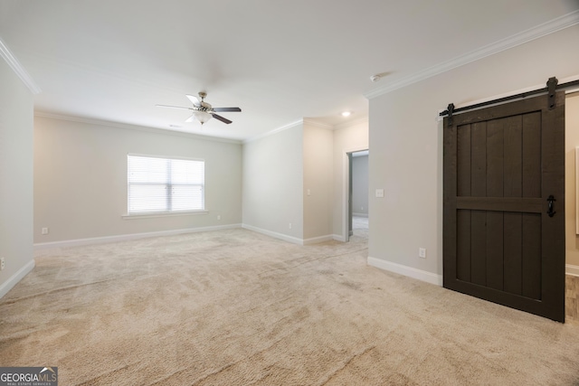 703 Burch Creek Dr, Grovetown, GA 30813 - carpeted empty room with a barn door, ceiling fan, ornamental molding, and a smoke detector
