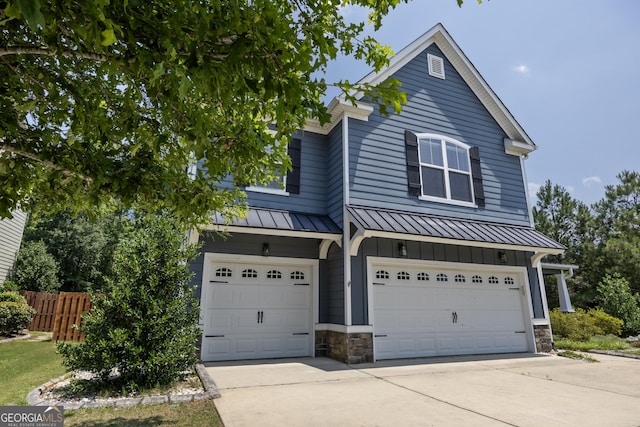 703 Burch Creek Dr, Grovetown, GA 30813 - view of front of home with a standing seam roof, a garage, a metal roof, and driveway