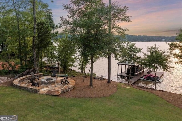 103 Jackson Ridge Dr, Monticello, GA 31064 - view of grassy yard with a fire pit, a water view, and a boat dock