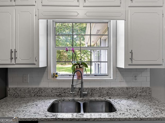 30 Court S, Ellenwood, GA 30294 - kitchen featuring a sink, white cabinets, tasteful backsplash, and healthy amount of natural light
