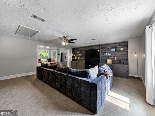 30 Court S, Ellenwood, GA 30294 - carpeted living area featuring attic access, a textured ceiling, baseboards, ceiling fan, and built in shelves