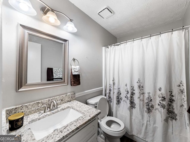 30 Court S, Ellenwood, GA 30294 - full bathroom with vanity, toilet, a textured ceiling, and a shower with shower curtain