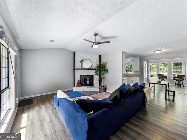 30 Court S, Ellenwood, GA 30294 - living area with wood finished floors, a textured ceiling, a fireplace, baseboards, and ceiling fan