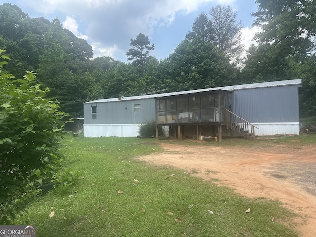 94 Payne Ln, Carnesville, GA 30521 - back of house with a sunroom, a lawn, and driveway