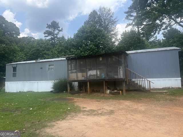 94 Payne Ln, Carnesville, GA 30521 - rear view of property featuring driveway and a lawn