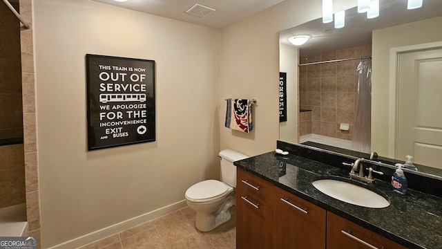 3300 Windy Ridge Pkwy SE, Atlanta, GA 30339 - full bath featuring a tile shower, toilet, vanity, tile patterned flooring, and baseboards