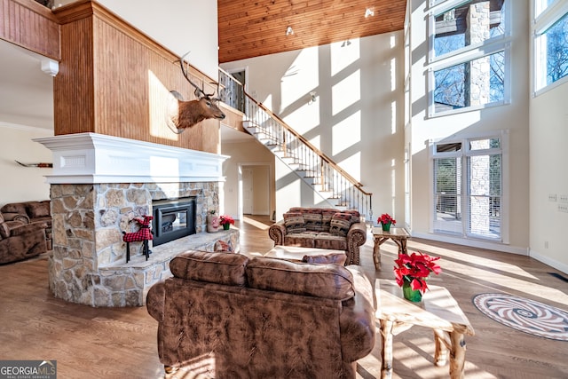 33 T J Mote Rd, Dahlonega, GA 30533 - living room with a towering ceiling, stairway, wood finished floors, a fireplace, and crown molding