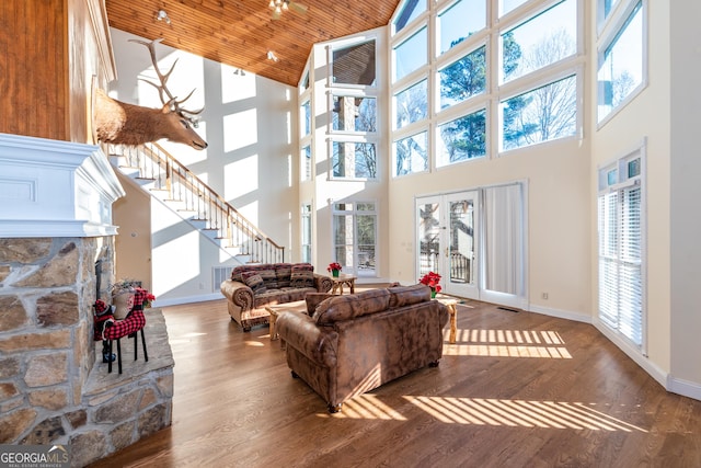 33 T J Mote Rd, Dahlonega, GA 30533 - living area with high vaulted ceiling, wood finished floors, baseboards, a stone fireplace, and wooden ceiling