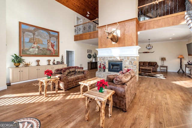 33 T J Mote Rd, Dahlonega, GA 30533 - living area featuring a towering ceiling, a fireplace, wood finished floors, baseboards, and crown molding
