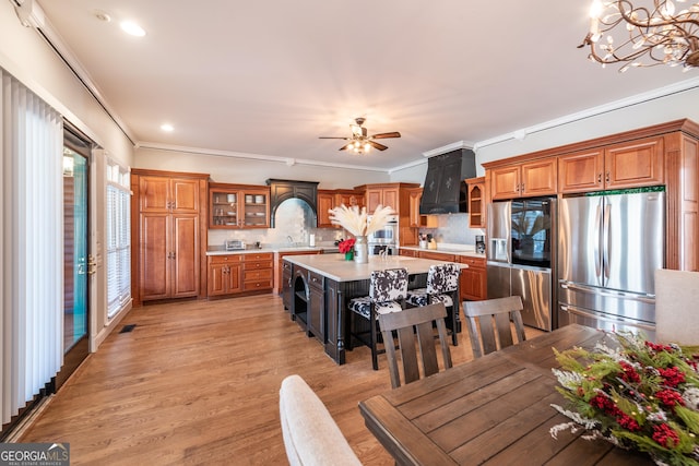 33 T J Mote Rd, Dahlonega, GA 30533 - kitchen with appliances with stainless steel finishes, premium range hood, light countertops, brown cabinets, and ornamental molding