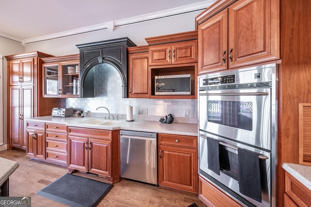 33 T J Mote Rd, Dahlonega, GA 30533 - kitchen featuring stainless steel appliances, a sink, brown cabinetry, light countertops, and crown molding