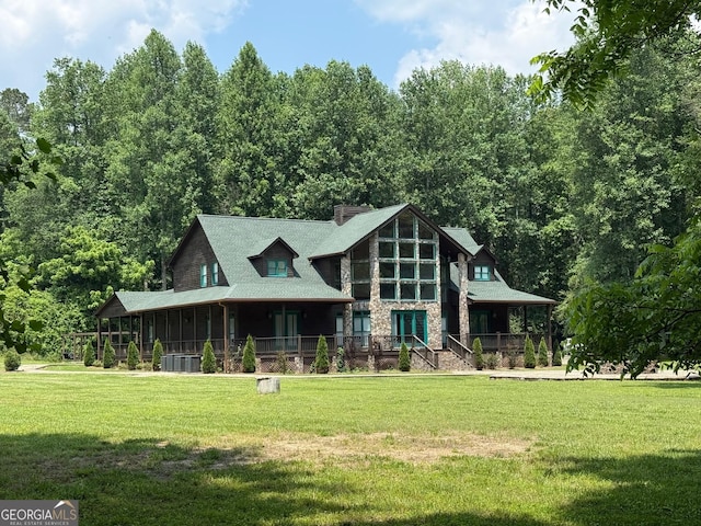 33 T J Mote Rd, Dahlonega, GA 30533 - view of front facade featuring stone siding, a front yard, a chimney, and central AC unit