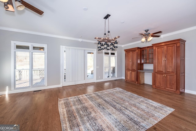 33 T J Mote Rd, Dahlonega, GA 30533 - unfurnished living room with a ceiling fan, dark wood finished floors, ornamental molding, baseboards, and a chandelier