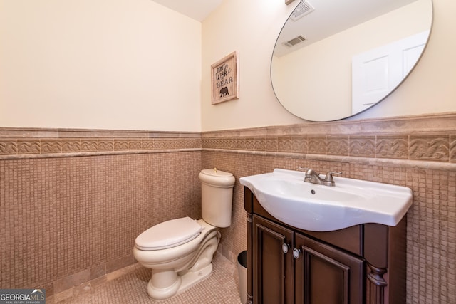 33 T J Mote Rd, Dahlonega, GA 30533 - bathroom with wainscoting, vanity, tile walls, toilet, and tile patterned flooring