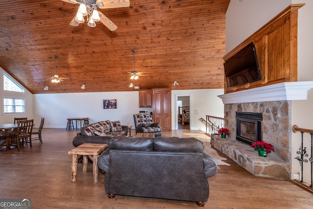 33 T J Mote Rd, Dahlonega, GA 30533 - living room featuring a ceiling fan, light wood-type flooring, wooden ceiling, a stone fireplace, and high vaulted ceiling