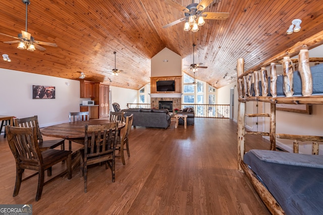 33 T J Mote Rd, Dahlonega, GA 30533 - dining area with a ceiling fan, a glass covered fireplace, wood finished floors, high vaulted ceiling, and wood ceiling