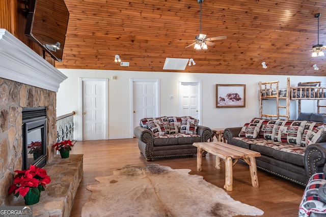 33 T J Mote Rd, Dahlonega, GA 30533 - living room featuring lofted ceiling, ceiling fan, a stone fireplace, and wood finished floors