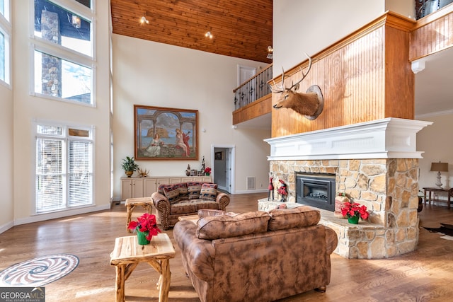 33 T J Mote Rd, Dahlonega, GA 30533 - living area with high vaulted ceiling, a fireplace, wood finished floors, wood ceiling, and baseboards