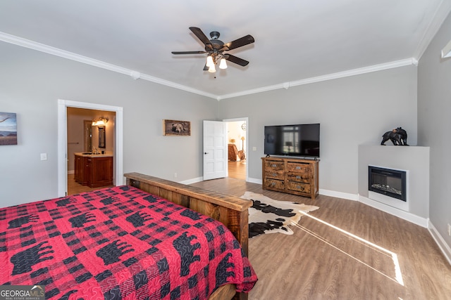 33 T J Mote Rd, Dahlonega, GA 30533 - bedroom featuring wood finished floors, ornamental molding, a glass covered fireplace, baseboards, and ensuite bathroom