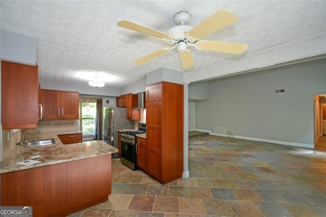 4766 Jamerson Forest Cir, Marietta, GA 30066 - kitchen with appliances with stainless steel finishes, dark stone finish floors, brown cabinets, a ceiling fan, and light stone countertops
