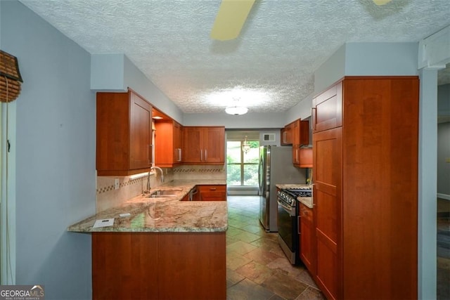 4766 Jamerson Forest Cir, Marietta, GA 30066 - kitchen with appliances with stainless steel finishes, a textured ceiling, decorative backsplash, brown cabinets, and light stone counters