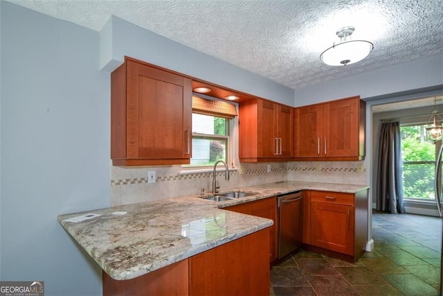 4766 Jamerson Forest Cir, Marietta, GA 30066 - kitchen featuring dishwasher, brown cabinets, plenty of natural light, tasteful backsplash, and a textured ceiling