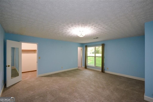 4766 Jamerson Forest Cir, Marietta, GA 30066 - carpeted empty room featuring a textured ceiling and baseboards