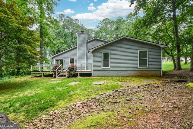 4766 Jamerson Forest Cir, Marietta, GA 30066 - back of house with a chimney, a deck, a lawn, and view of scattered trees