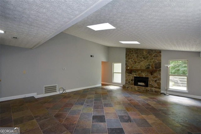 4766 Jamerson Forest Cir, Marietta, GA 30066 - unfurnished living room with plenty of natural light, a textured ceiling, a fireplace, and lofted ceiling