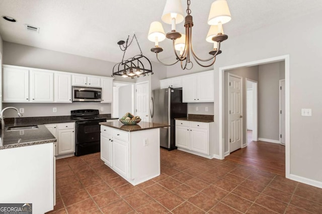 144 Nocatee Trl, Woodstock, GA 30188 - kitchen featuring stainless steel appliances, a chandelier, a kitchen island, and white cabinets
