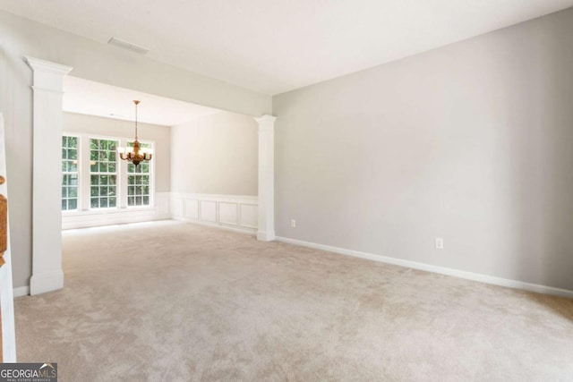144 Nocatee Trl, Woodstock, GA 30188 - carpeted empty room featuring a chandelier and ornate columns