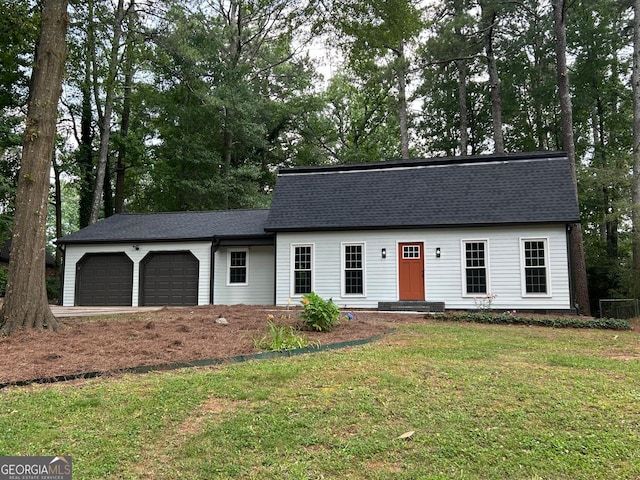 4617 Cedar Park Dr, Stone Mountain, GA 30083 - view of front of house with an attached garage, a front lawn, a shingled roof, and view of wooded area