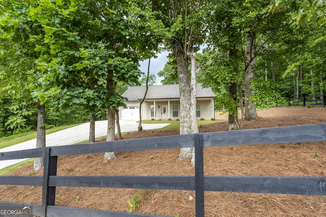 1960 York Dr, Canton, GA 30114 - ranch-style house with a fenced front yard, concrete driveway, and an attached garage