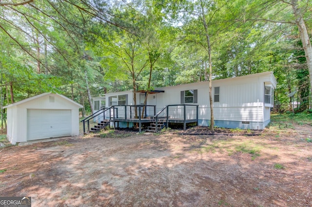 2526 Bald Eagle Trl, Gainesville, GA 30507 - view of front of home with crawl space, an outbuilding, a detached garage, a wooden deck, and driveway