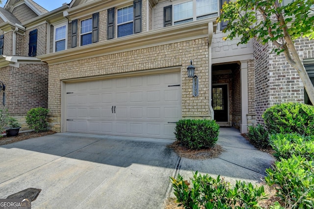 5016 Garrett Ct, Alpharetta, GA 30005 - property entrance with a garage, brick siding, and driveway
