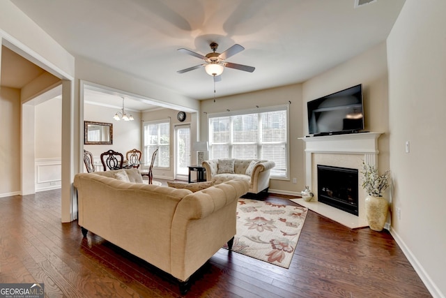 5016 Garrett Ct, Alpharetta, GA 30005 - living room with a ceiling fan, dark wood-style flooring, a high end fireplace, and a chandelier