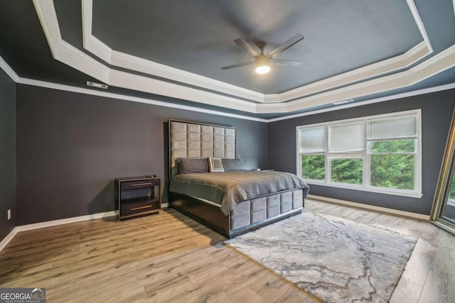 1979 Alcovy Shoals Blf, Lawrenceville, GA 30045 - bedroom featuring a tray ceiling, ornamental molding, wood finished floors, and a ceiling fan