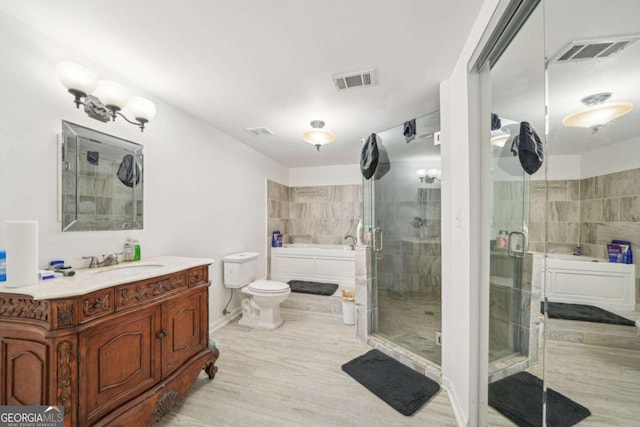 1979 Alcovy Shoals Blf, Lawrenceville, GA 30045 - full bathroom with a bath, vanity, a stall shower, wood finished floors, and tile walls